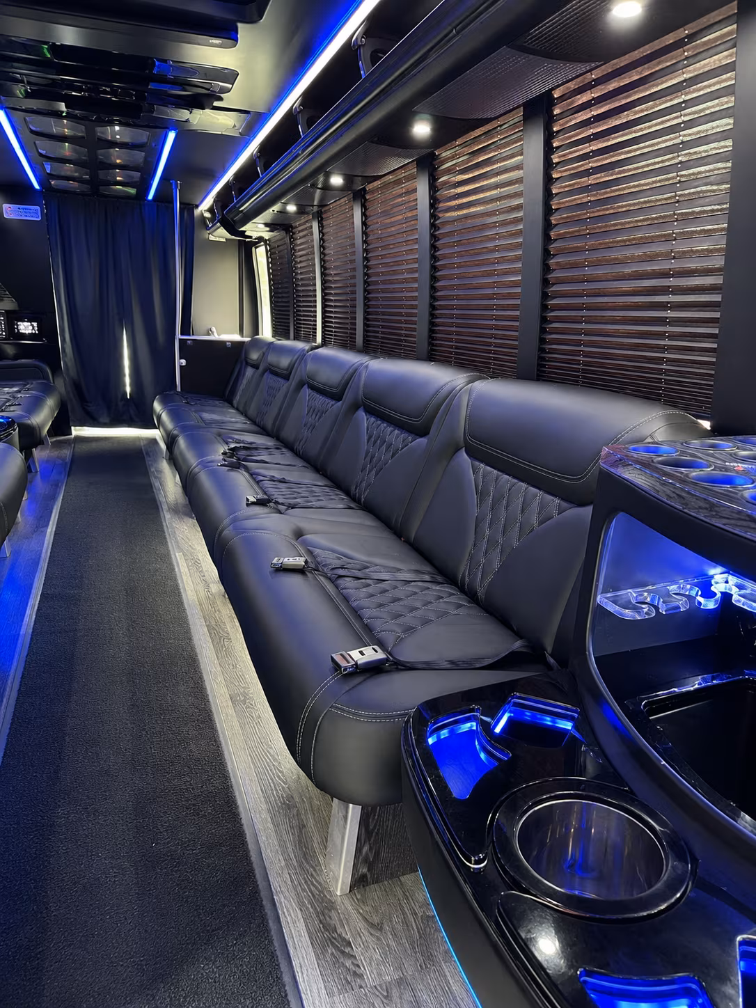Friends laughing during a party bus celebration in Naples